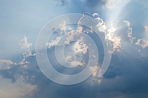 Low Angle View Of Clouds In Sky. Epic storm cloudscape. Soft sunlight, sun rays. Clear blue sky. Natural pattern, texture,