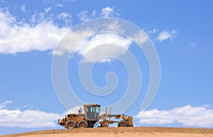 Cloudscape and road grader