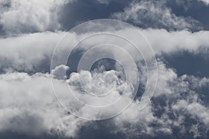 Cloudscape scenery, overcast weather above dark blue sky. Storm clouds floating in a rainy dull day with natural light. White and