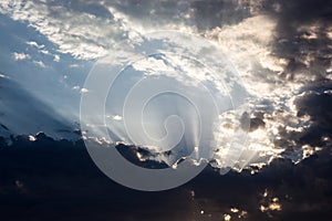 Cloudscape with the sun rays radiating from behind the cloud