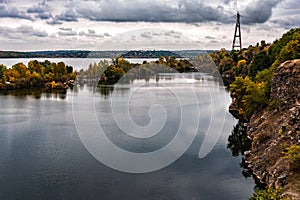 Cloudy autumn day. Old Kodax. Granite quarry flooded with water. Dnieper River.