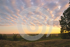 Cloudy autumn morning. Fresh nature. Bright sunrise in the meadow.