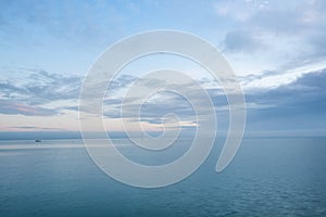 Cloudy blue minimalist seascape. Deserted space with horizon line