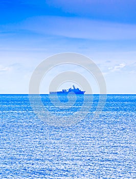 Cloudy blue sky above a battleship