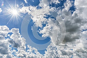 Cloudy Blue Sky as Background. Direct Sunlight, Sun Above the Clouds