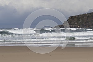 Cloudy day in a beach with strong swell