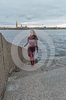 Cloudy day a beautiful girl on the waterfront