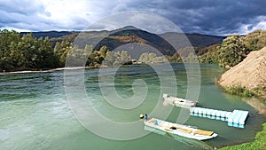 A cloudy day on river Drina, Bajina Basta, Serbia with boats in foreground photo