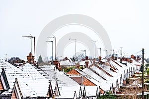 Cloudy Day Winter View of Row of Typical English Terraced Houses under snow in Northampton