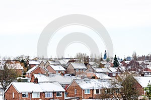 Cloudy Day Winter View of Row of Typical English Terraced Houses under snow in Northampton