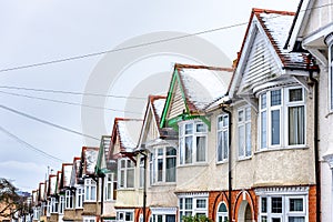 Cloudy Day Winter View of Row of Typical English Terraced Houses under snow in Northampton