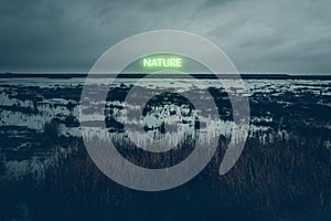Cloudy dune landscape with green neon lettering nature photo