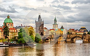 Cloudy evening in Prague old town, view at the Charles Bridge over Moldava river