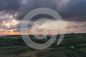 Cloudy evening sky. Sunset. Hilly terrain