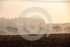 cloudy and foggy sunrise over slovakian landscape in autumn