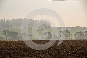 cloudy and foggy sunrise over slovakian landscape in autumn