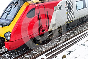 Cloudy foggy winter day view of Train on UK Railroad in England. Emma storm railway landscape.