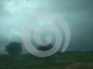 Cloudy green blue sky over a jungle or forest in evening night of rainy weather in india