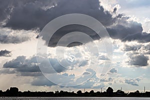Cloudy with light over flooded countryside.