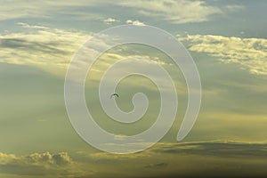 Cloudy mood over Lake Garda in Italy. Dark clouds against the bright sky. A bird flies lonely across the sky. Scraps of cloud