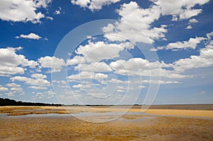 Cloudy morningon the beach with a sky-blue sky can be seen between clouds. photo