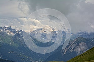 Cloudy mountainpeaks with glaciers in the French Alps