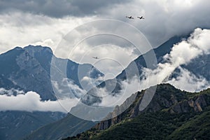 Cloudy mountains and planes passing by