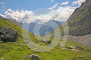 Cloudy mountains and valle with little river y  in the French Alps