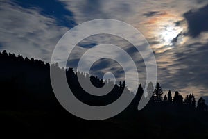 Cloudy night sky with the moon in the mountains Pieniny, Poland