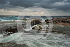 Cloudy seascape with flowing water