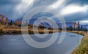 Cloudy skies and mountains in fall at sunrise