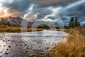 Cloudy skies and mountains in fall at sunrise