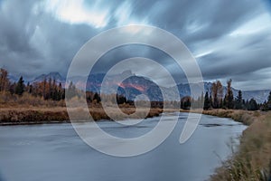 Cloudy skies and mountains in fall at sunrise