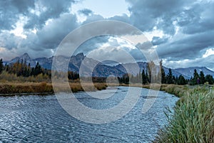 Cloudy skies and mountains in fall at sunrise