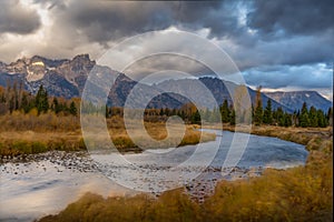 Cloudy skies and mountains in fall at sunrise