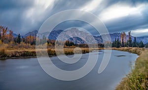 Cloudy skies and mountains in fall at sunrise