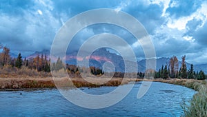 Cloudy skies and mountains in fall at sunrise