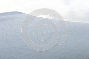 Cloudy skies over a mountain of freshly fallen snow