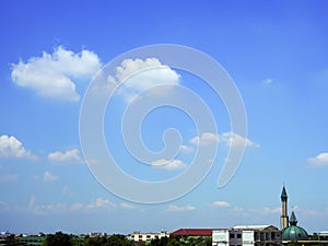 Cloudy sky background with ancient muslim mosque in residential