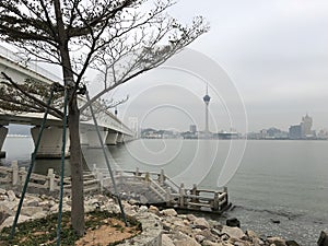 Cloudy sky and cold wind in Macua city with city bridge and waterfront.