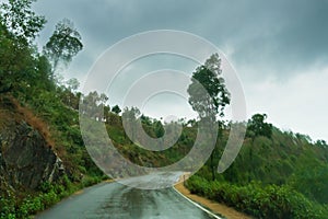Cloudy sky and curve of Himalayan road, monsoon landscape of Garhwal, Uttarakhand, India. Climate change effect on Himalays