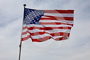 Cloudy sky and the flag of the United States