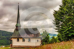 Cloudy sky over an church in Furtwangen city in Black Forest, Germany