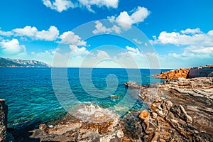 Cloudy sky over Rocce Rosse shore in Sardinia