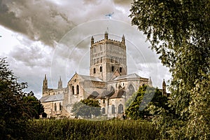 Cloudy sky over Tewkesbury Abbey, Gloucestershire which has a Norman edifice and Romanesque tower