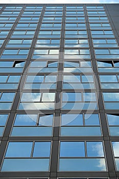 Cloudy sky reflection on glass surface of modern building