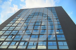 Cloudy sky reflection on glass surface of modern building