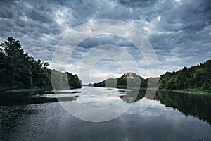 Cloudy sky on the river in the summer evening