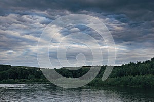 Cloudy sky on the river in the summer evening