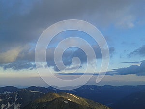 Cloudy sky at sunset over mountain top